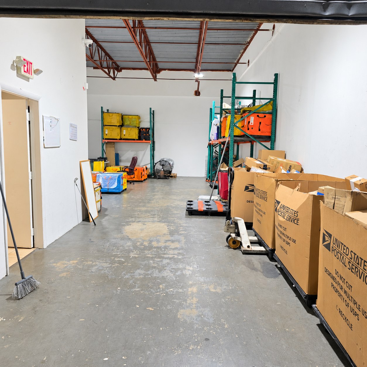 Warehouse aisle at DOC Logistics Hub with parcels staged along storage racks